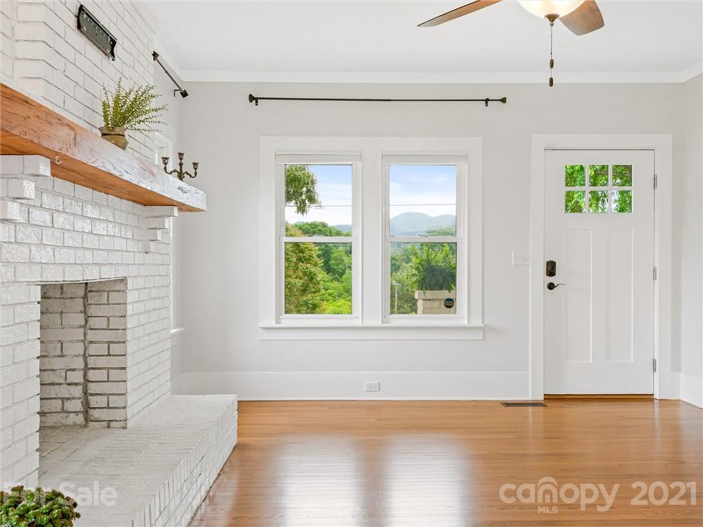 714 Queentown Road Canton, NC 28716 - Photo 2 of 21 a view of an empty room with a window and wooden floor