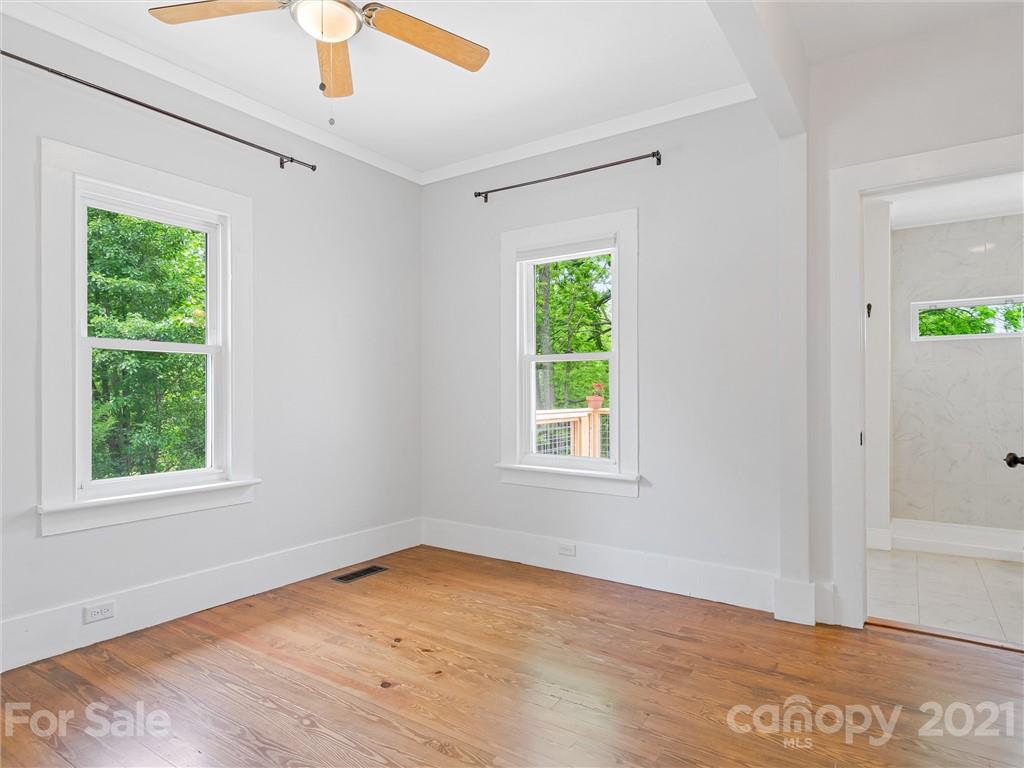 714 Queentown Road Canton, NC 28716 - Photo 9 of 21 an empty room with wooden floor and windows