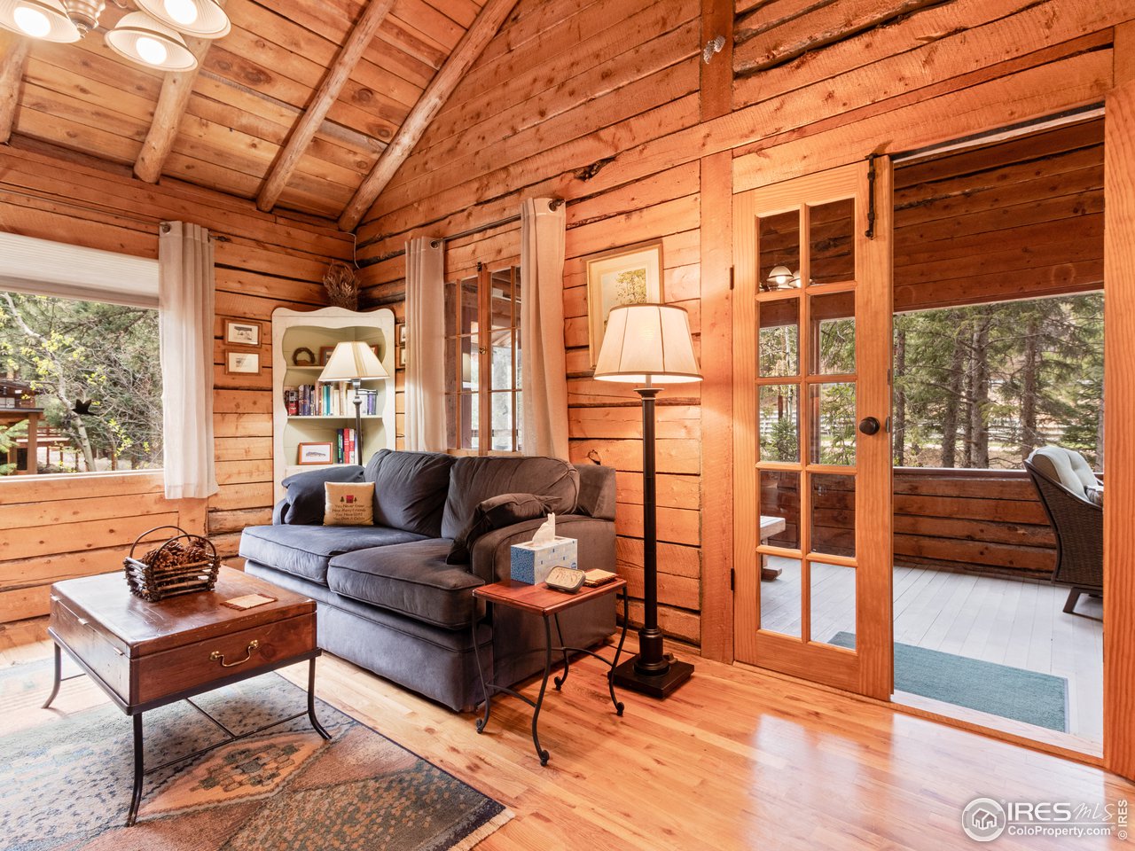 43 Riverside Drive Lyons, CO 80540 - Photo 9 of 20 Living room leading to enclosed porch