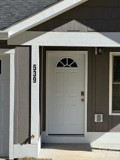 a front view of a house with white wooden wall