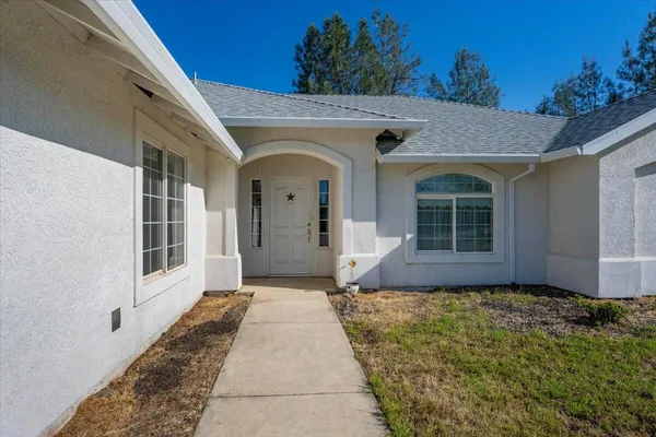 a front view of a house with a yard
