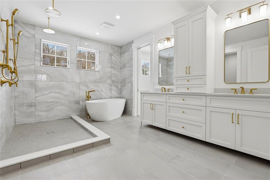 1502 Powers Run Road Pittsburgh, PA 15238 - Photo 17 of 33 a spacious bathroom with a double vanity sink a mirror and a bathtub
