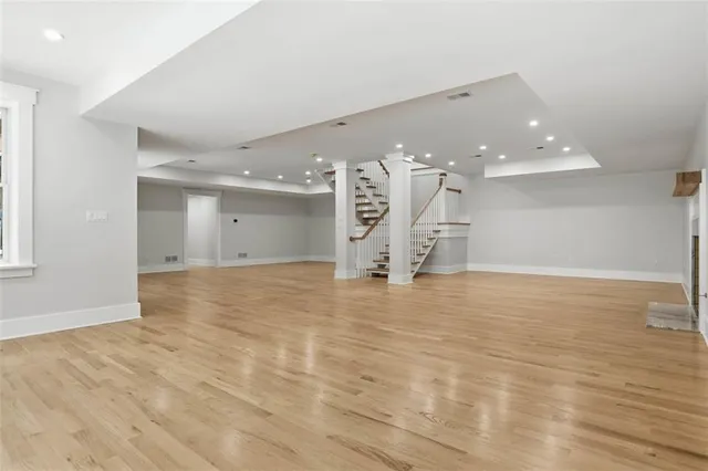 a view of empty room with wooden floor