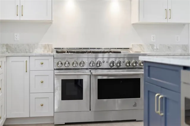 a stove top oven sitting inside of a kitchen