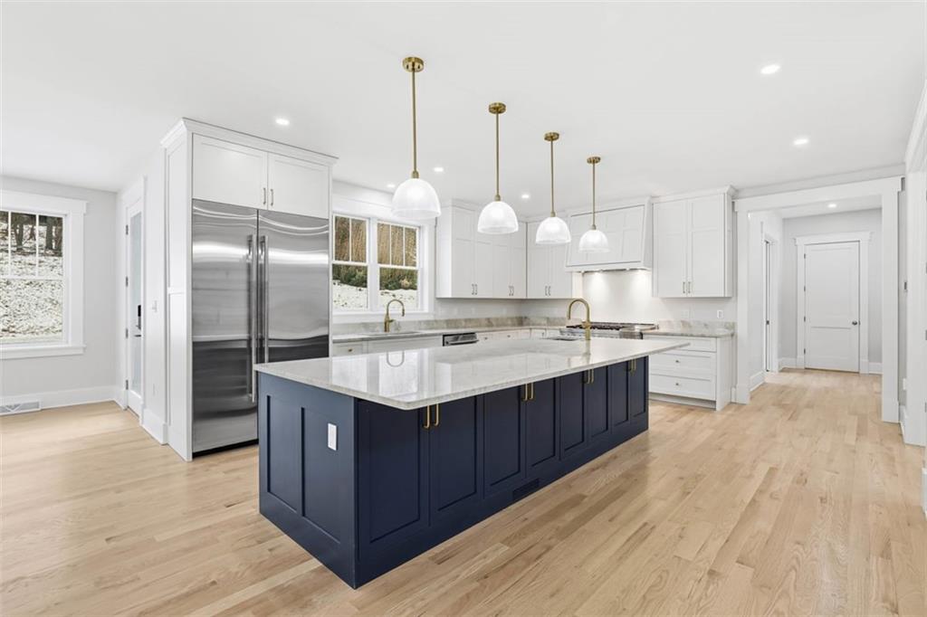 1502 Powers Run Road Pittsburgh, PA 15238 - Photo 5 of 33 a kitchen with kitchen island granite countertop a sink and a refrigerator