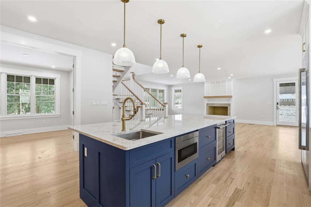 1502 Powers Run Road Pittsburgh, PA 15238 - Photo 8 of 33 a kitchen with kitchen island a sink stove and wooden floor