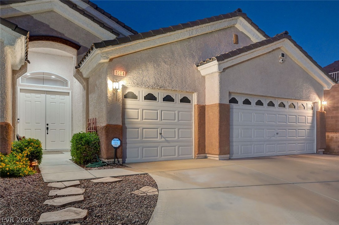 1604 Cattle Ranch Place Henderson, NV 89002 - Photo 84 of 99 A well-lit entryway welcomes visitors, flanked by a convenient two-car garage.
