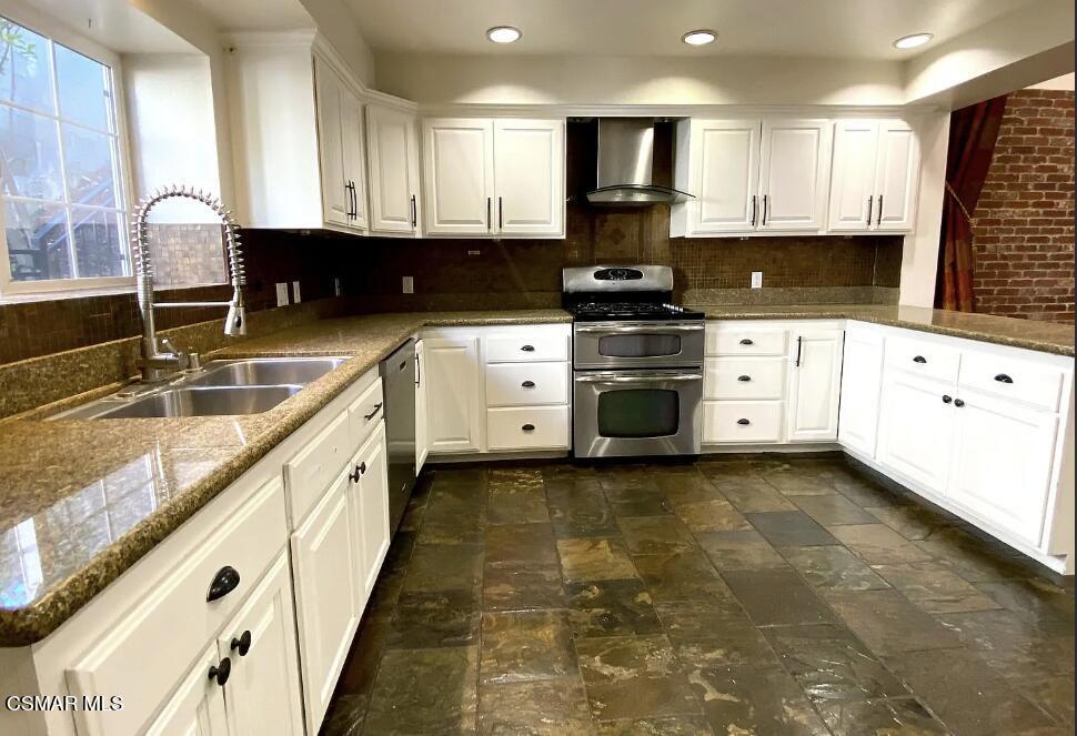 4130 Carrizal Road Woodland Hills, CA 91364 - Photo 13 of 33 a kitchen with granite countertop a sink a stove and cabinets