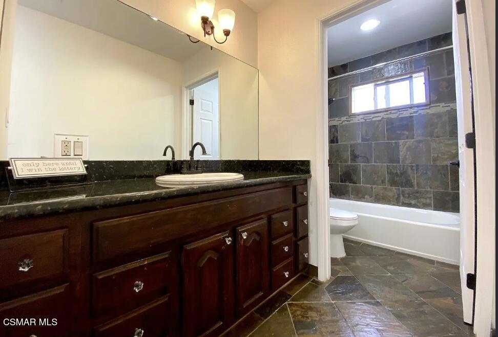 4130 Carrizal Road Woodland Hills, CA 91364 - Photo 26 of 33 a bathroom with a granite countertop sink a toilet and bathtub