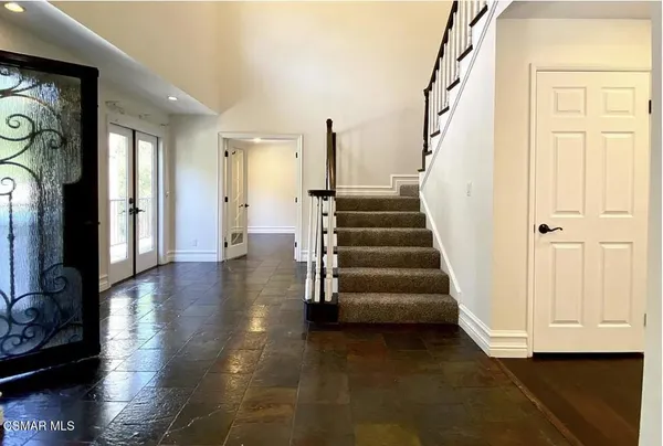 a view of entryway with wooden floor and stairs
