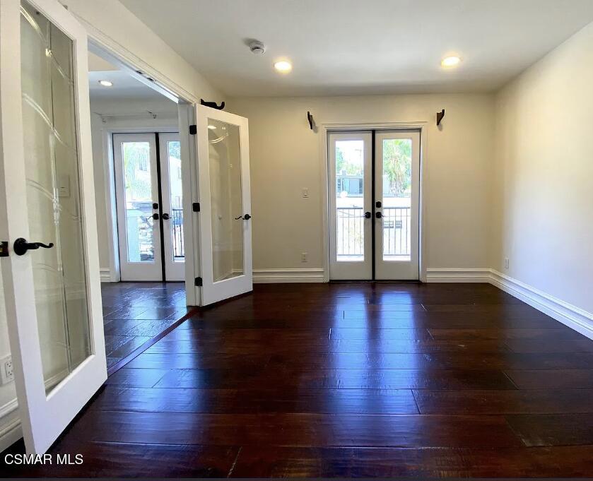 4130 Carrizal Road Woodland Hills, CA 91364 - Photo 7 of 33 an empty room with wooden floor and windows
