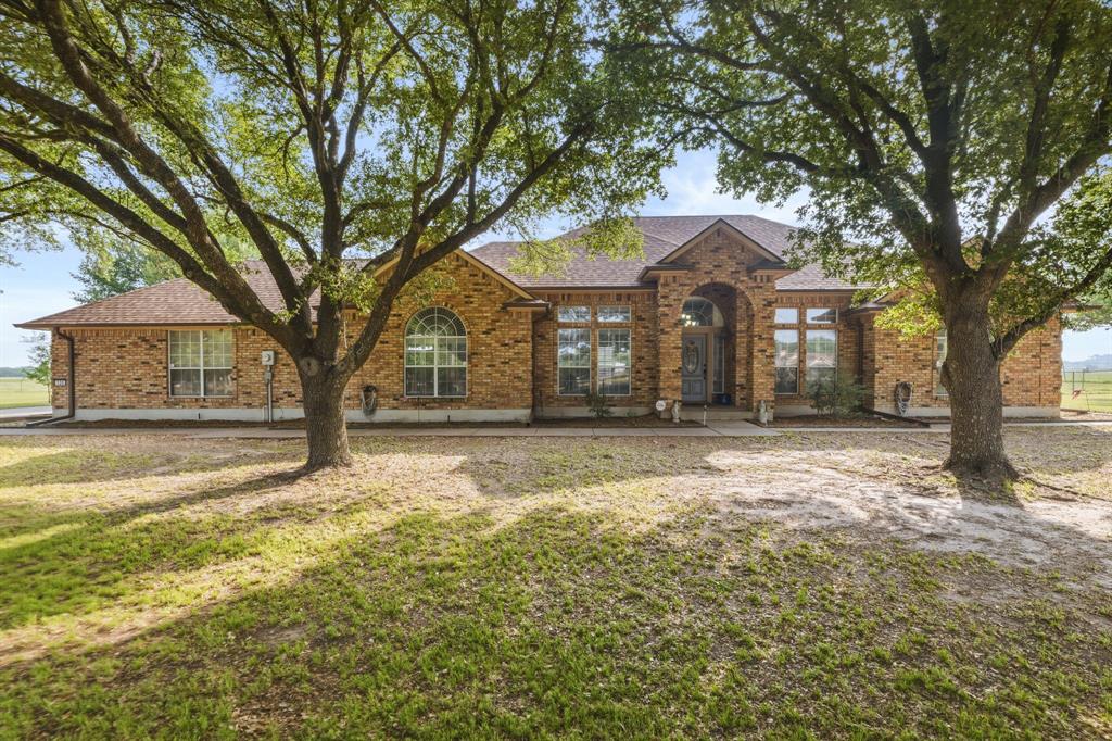 130 Blazek Road Alma, TX 75119 - Photo 2 of 34 a front view of a house with a yard and large trees