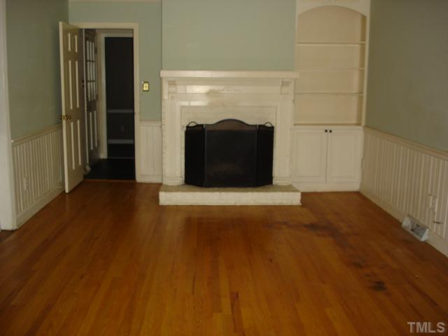 2807 Anderson Drive Raleigh, NC 27608 - Photo 3 of 15 a view of a big room with wooden floor and brick wall