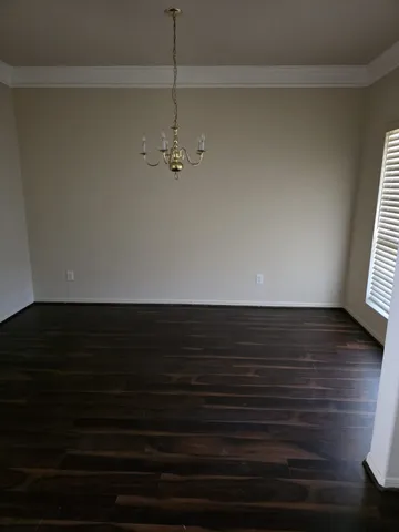 a view of room with hardwood floor and ceiling fan