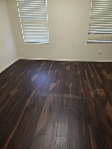 a view of wooden floor and windows in a room