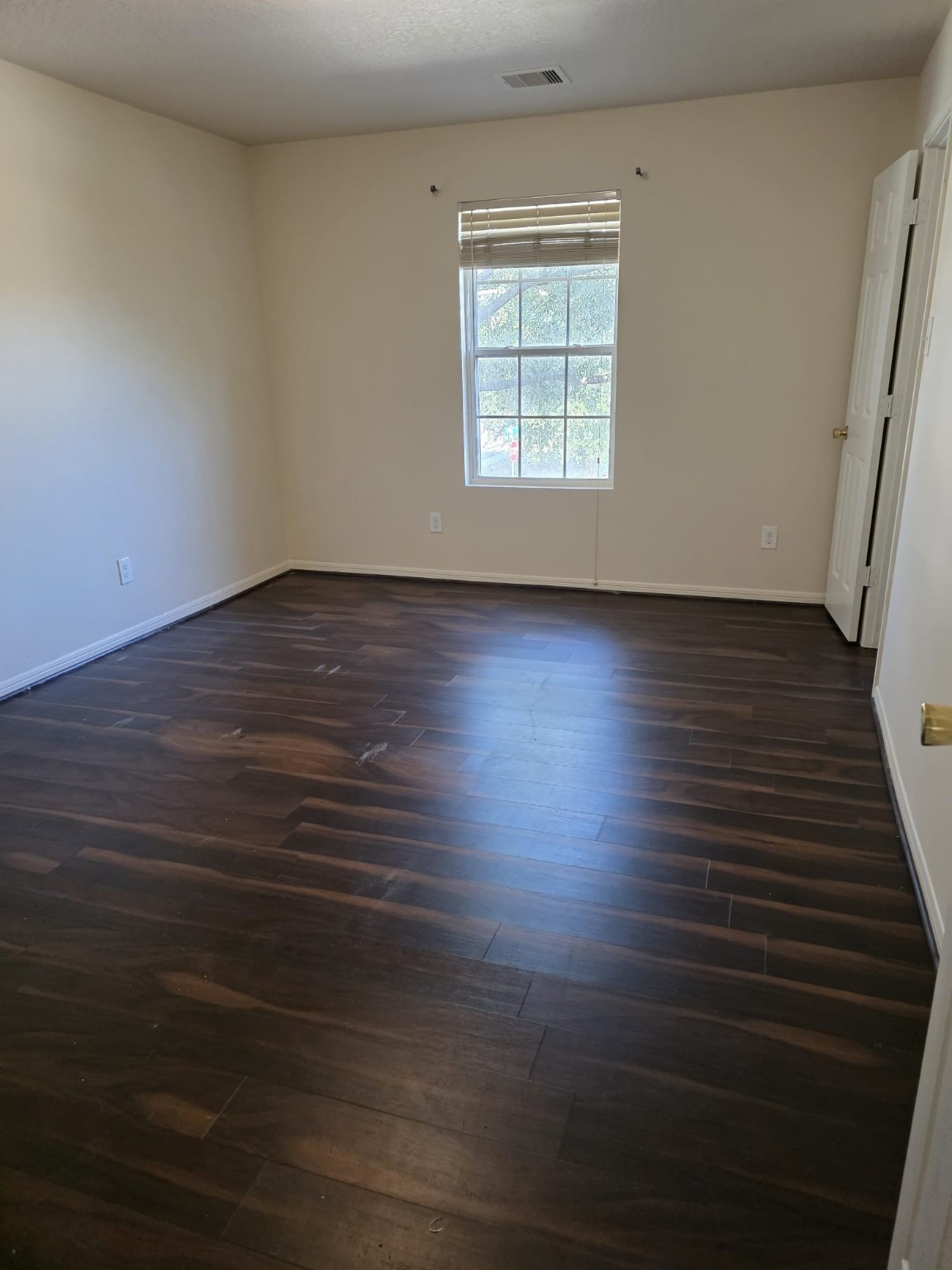 1023 Orie Court Spring, TX 77373 - Photo 25 of 28 an empty room with wooden floor and windows