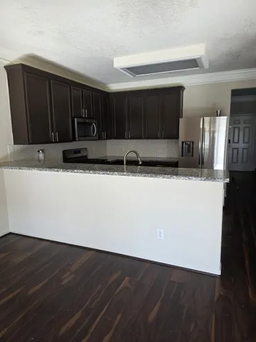 a view of a kitchen with a sink and cabinets