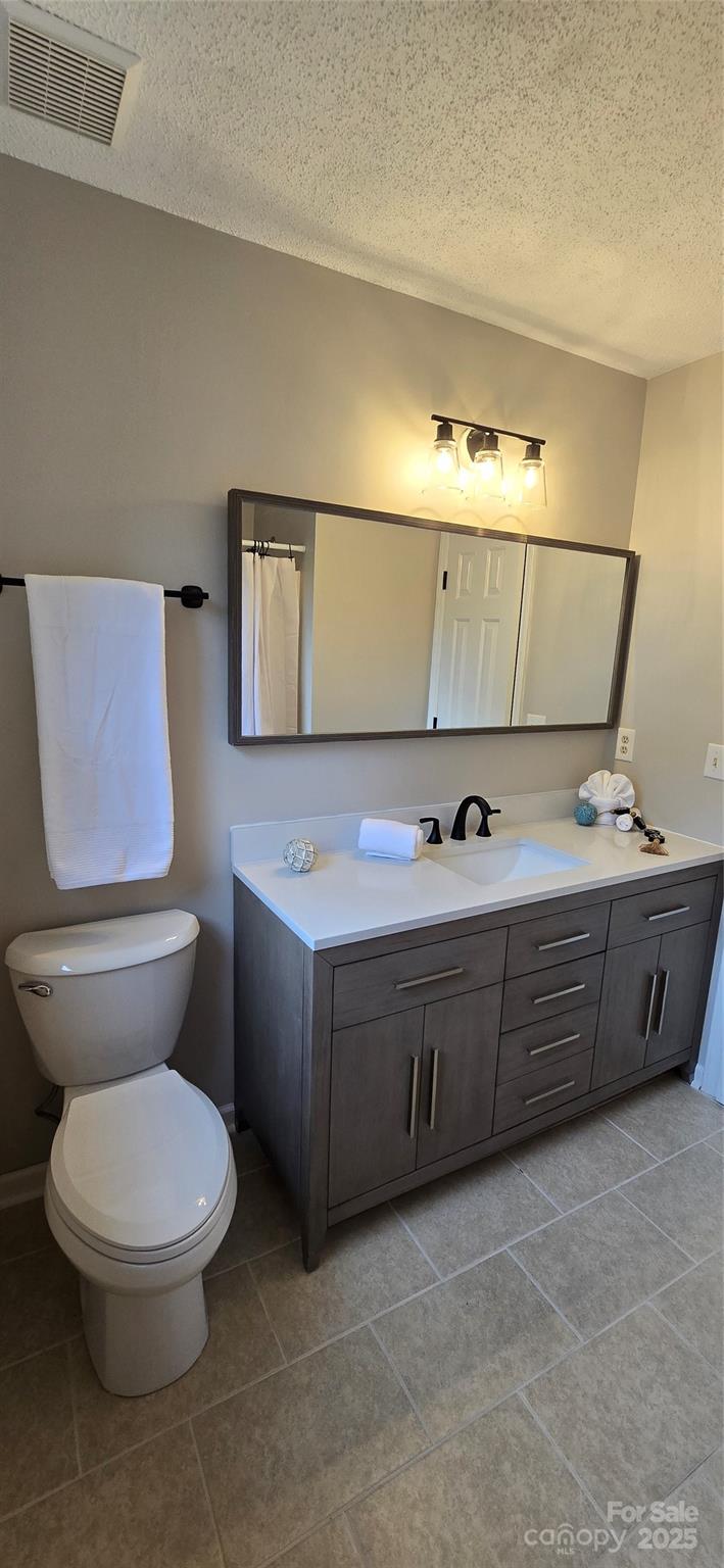 413 Parallel Drive Harrisburg, NC 28075 - Photo 12 of 40 a bathroom with a toilet sink and mirror