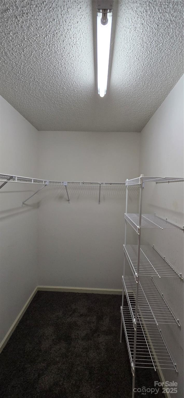 413 Parallel Drive Harrisburg, NC 28075 - Photo 17 of 40 a view of storage and utility room with racks on the wall