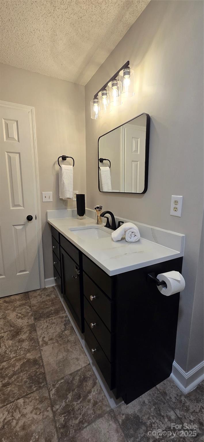 413 Parallel Drive Harrisburg, NC 28075 - Photo 18 of 40 a bathroom with a sink vanity and a mirror