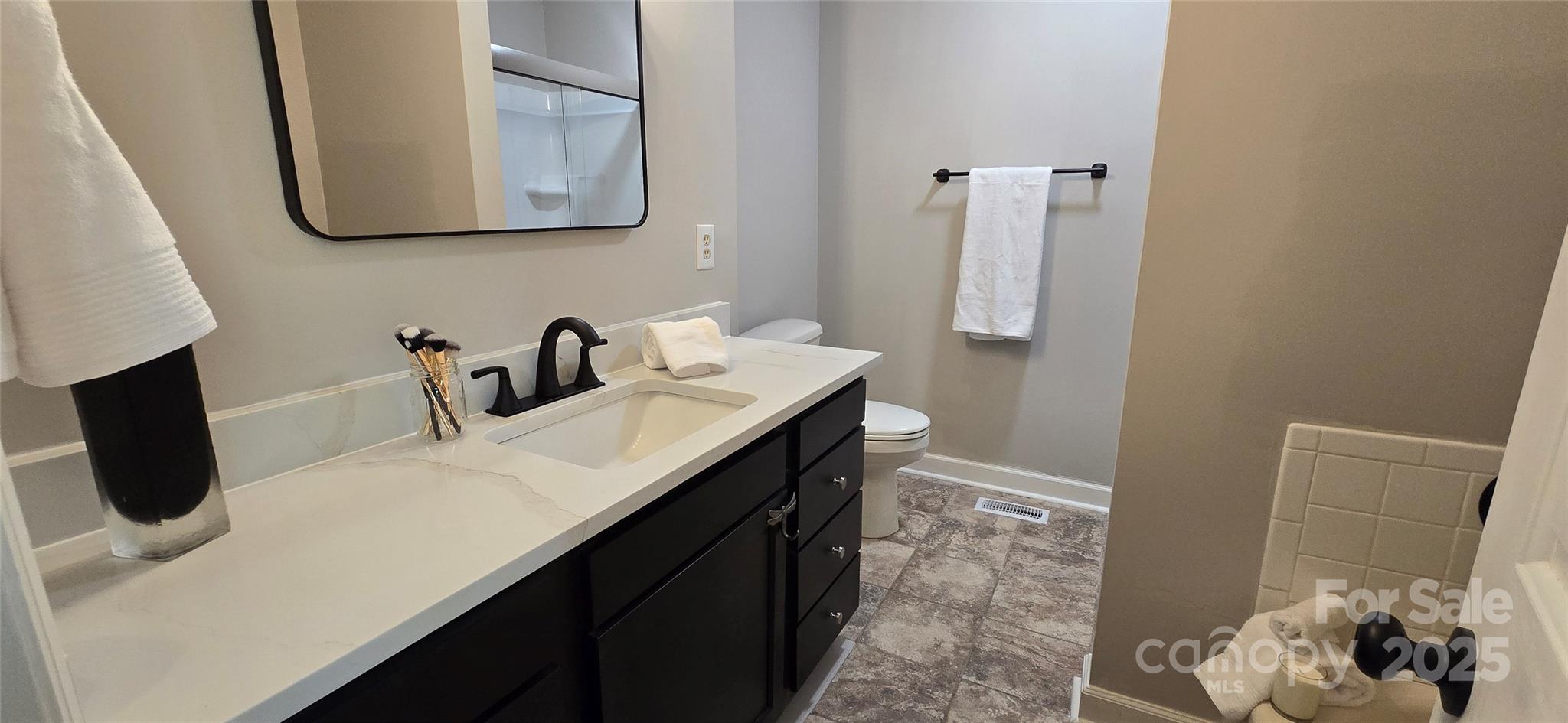 413 Parallel Drive Harrisburg, NC 28075 - Photo 20 of 40 a bathroom with a sink and a mirror