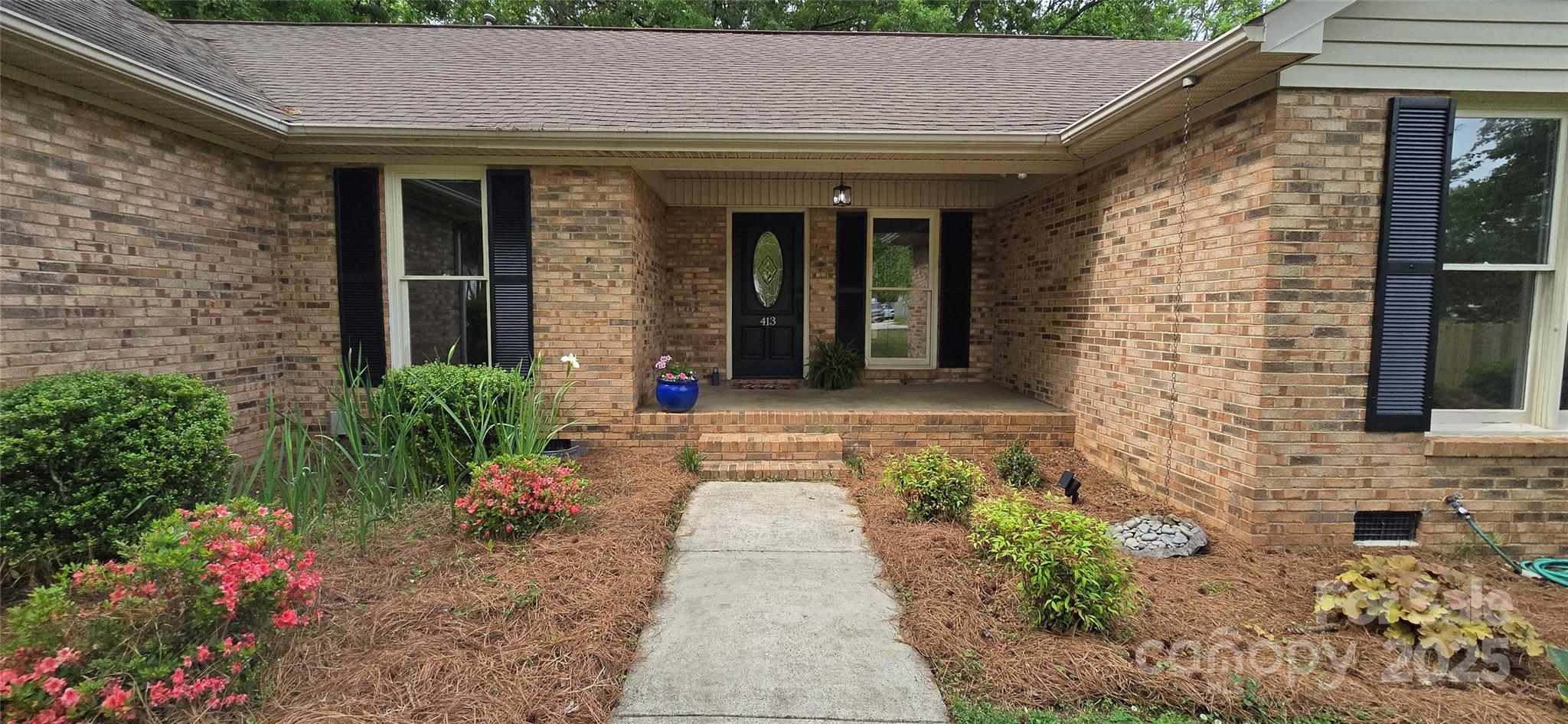 413 Parallel Drive Harrisburg, NC 28075 - Photo 2 of 40 a view of a pathway both side of the house