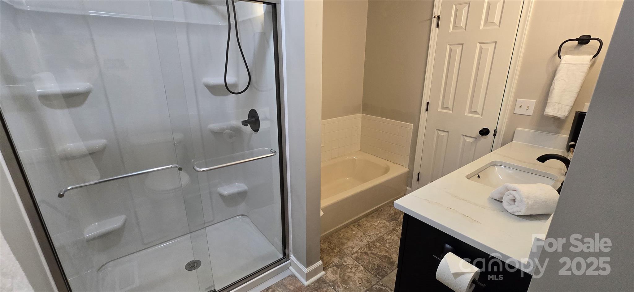 413 Parallel Drive Harrisburg, NC 28075 - Photo 21 of 40 a bathroom with a granite countertop shower and a sink