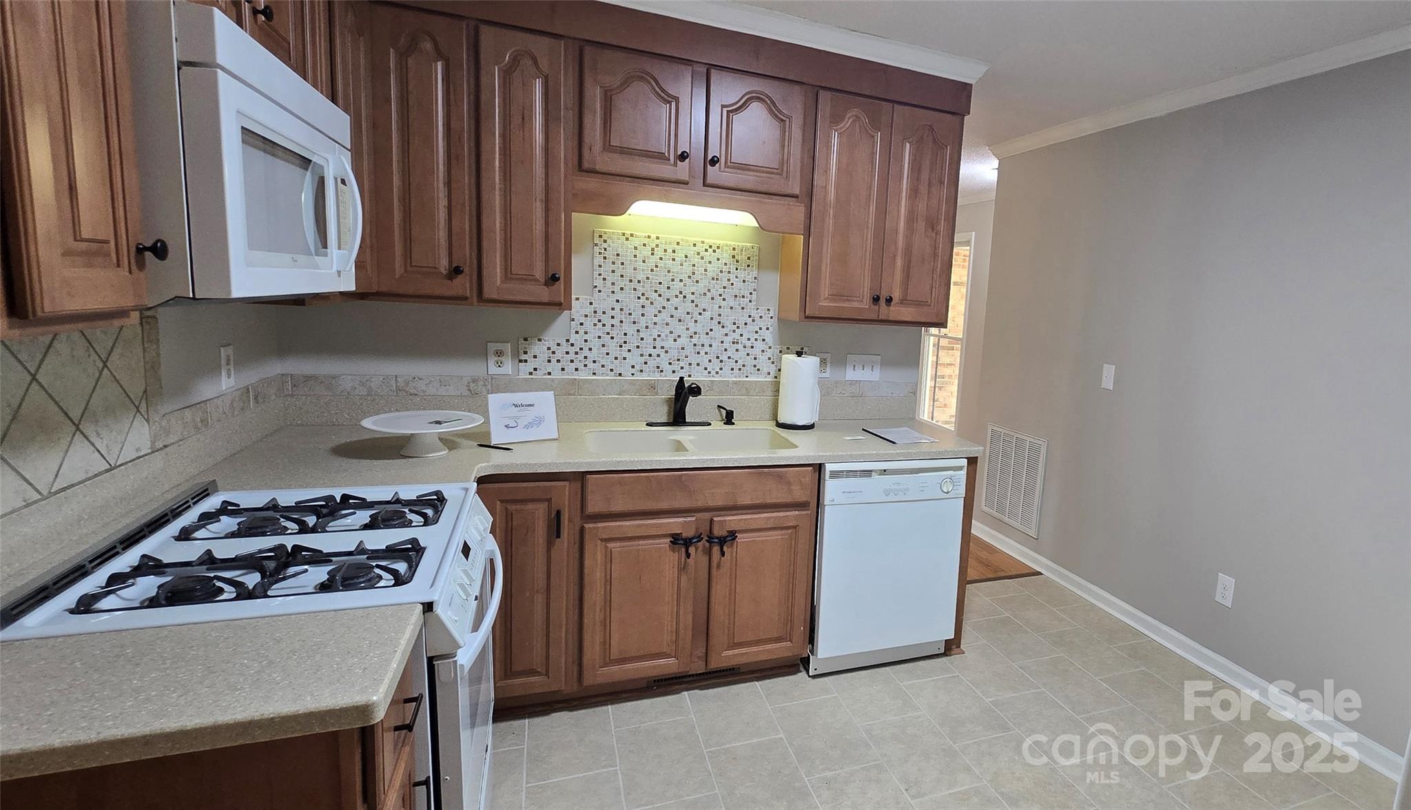 413 Parallel Drive Harrisburg, NC 28075 - Photo 24 of 40 a kitchen with stainless steel appliances a stove a sink and a microwave