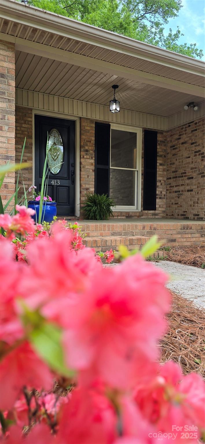 413 Parallel Drive Harrisburg, NC 28075 - Photo 3 of 40 a view of yellow house with a yard