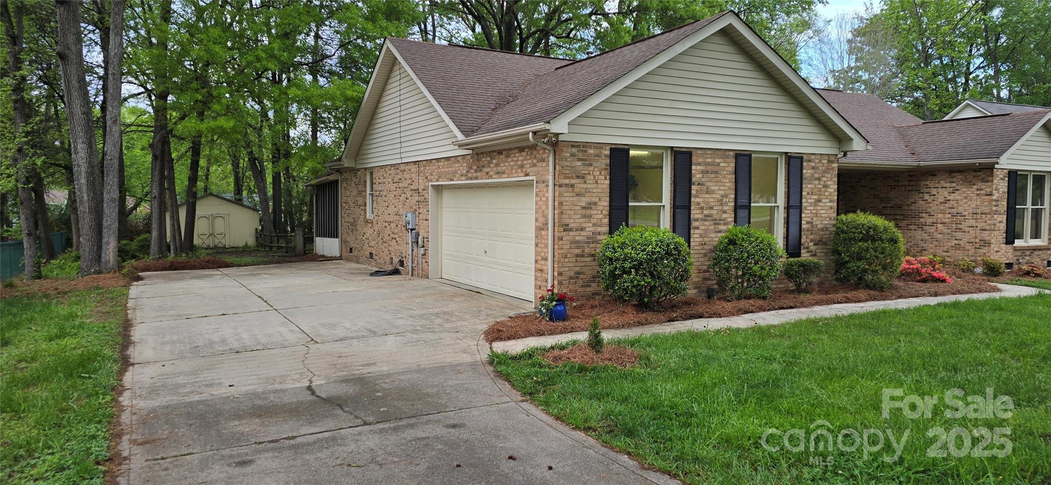 413 Parallel Drive Harrisburg, NC 28075 - Photo 32 of 40 a view of a house with a yard and potted plants