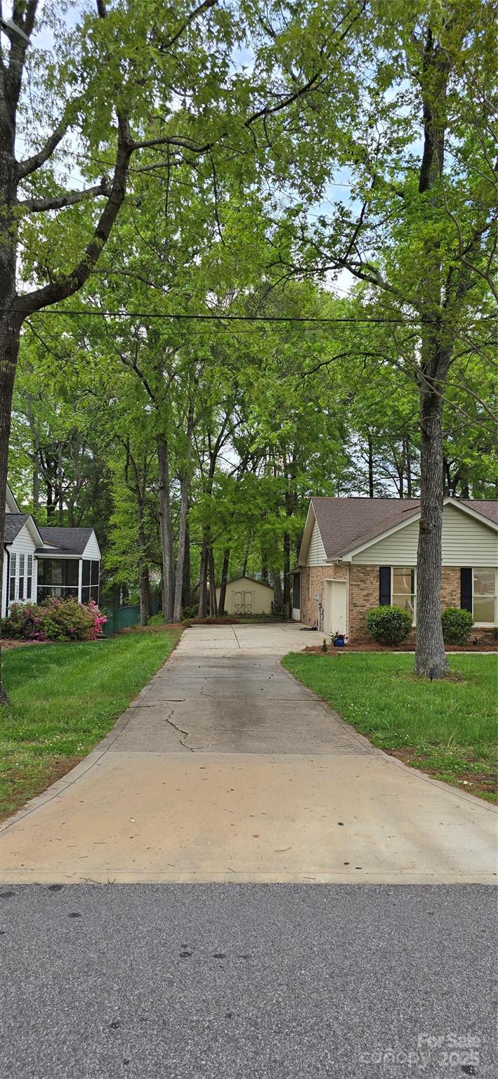 413 Parallel Drive Harrisburg, NC 28075 - Photo 33 of 40 a view of a house with a yard and large tree