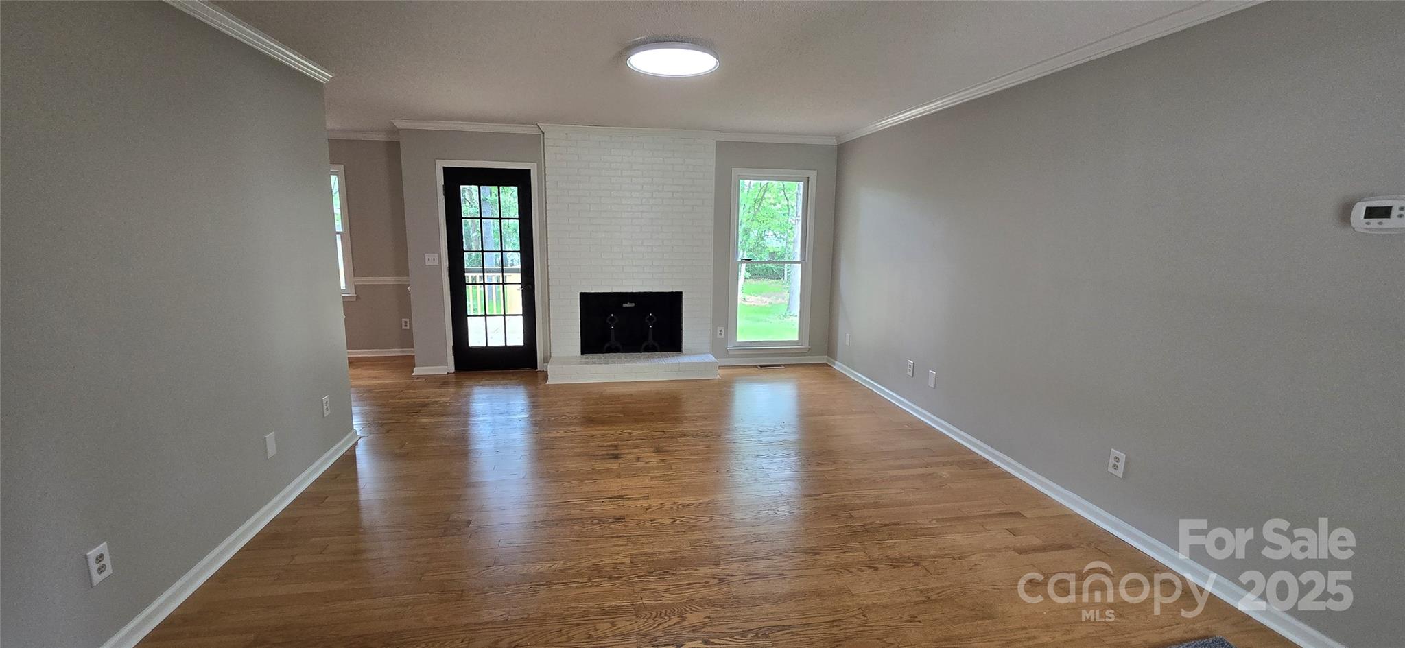 413 Parallel Drive Harrisburg, NC 28075 - Photo 7 of 40 wooden floor in an empty room with a window