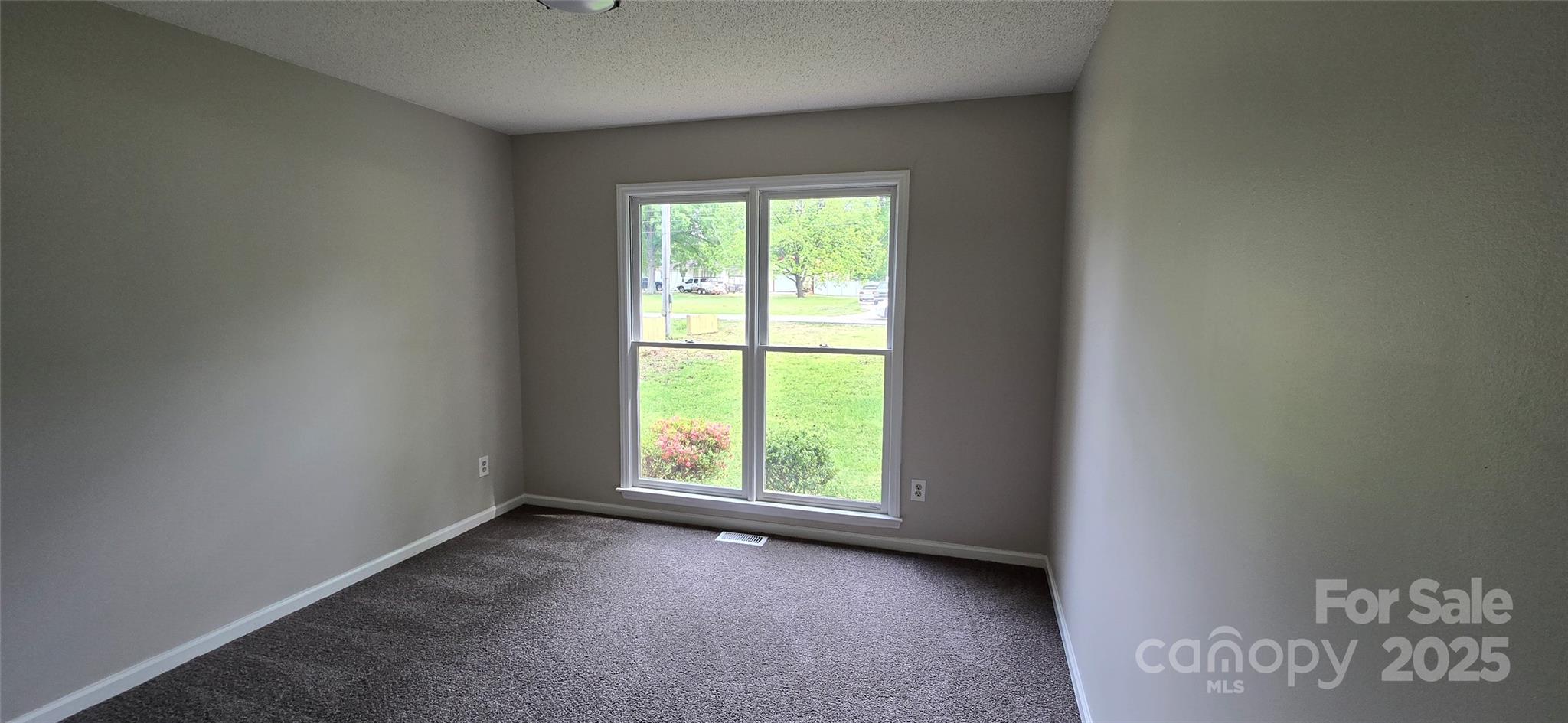 413 Parallel Drive Harrisburg, NC 28075 - Photo 9 of 40 an empty room with a window