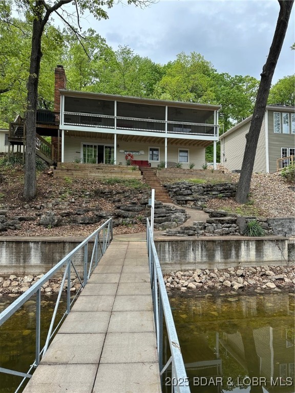 32 Lake Village Road Eldon, MO 65026 - Photo 2 of 49 Back facing lake with full length screened porch