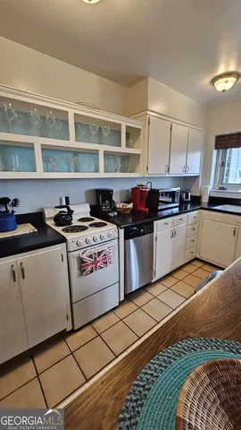 a living room with furniture fireplace and a window