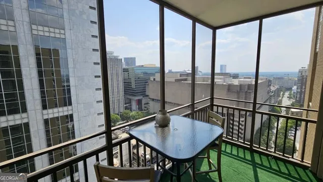 a view of a porch with furniture and wooden deck