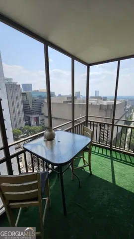 a view of a chair and table on the deck