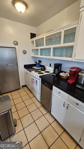 a kitchen with stainless steel appliances a sink window and cabinets