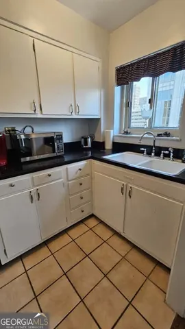 a kitchen with stainless steel appliances granite countertop a sink and cabinets