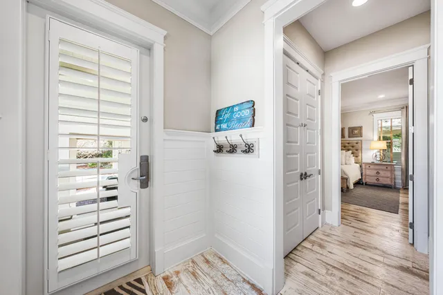 a view of a hallway with wooden floor and staircase