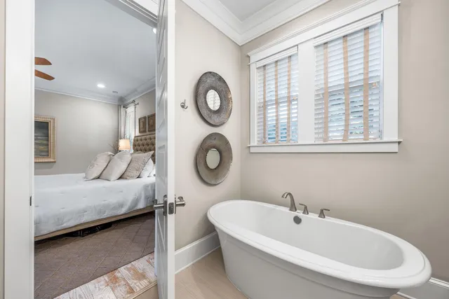 a bedroom with a large bed and windows