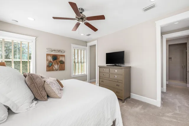 a bedroom with a bed and windows