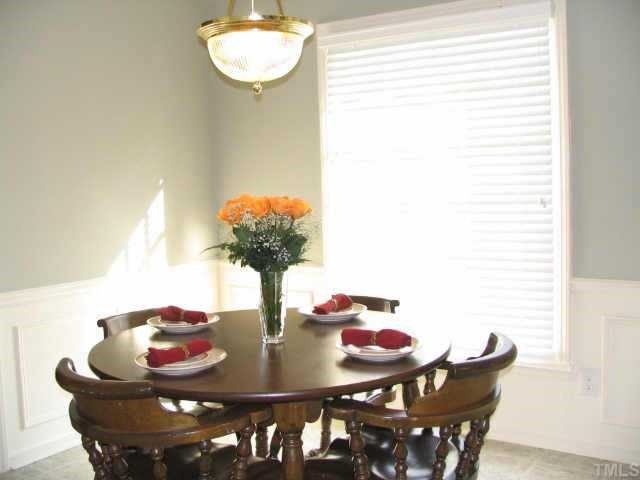 7500 Old Hundred Road Raleigh, NC 27613 - Photo 3 of 9 a dining room with furniture and wooden floor