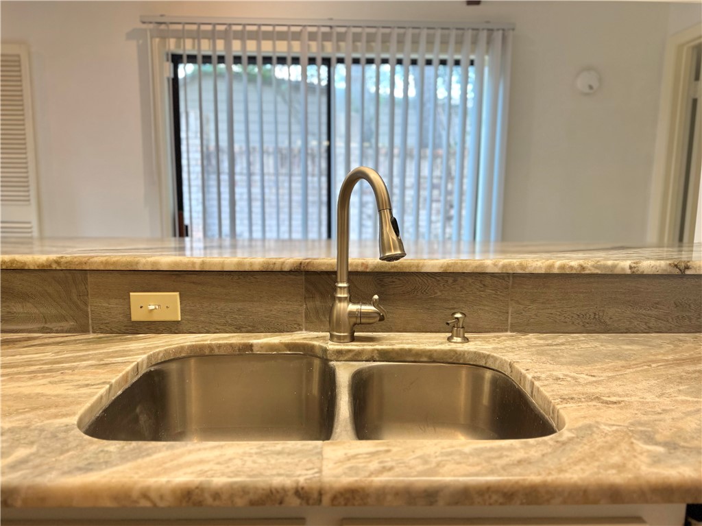 2611 Rustling Oaks Drive Bryan, TX 77802 - Photo 16 of 43 a kitchen with a sink and a large mirror