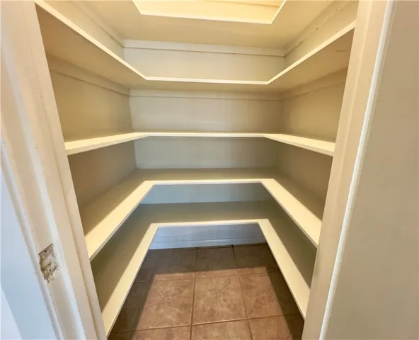 a view of walk in closet with wooden floor