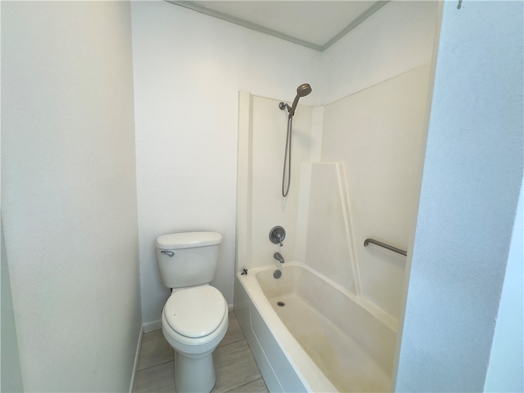 2611 Rustling Oaks Drive Bryan, TX 77802 - Photo 23 of 43 a white toilet sitting next to a bath tub