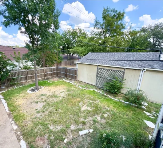 a view of a backyard with plants and a patio