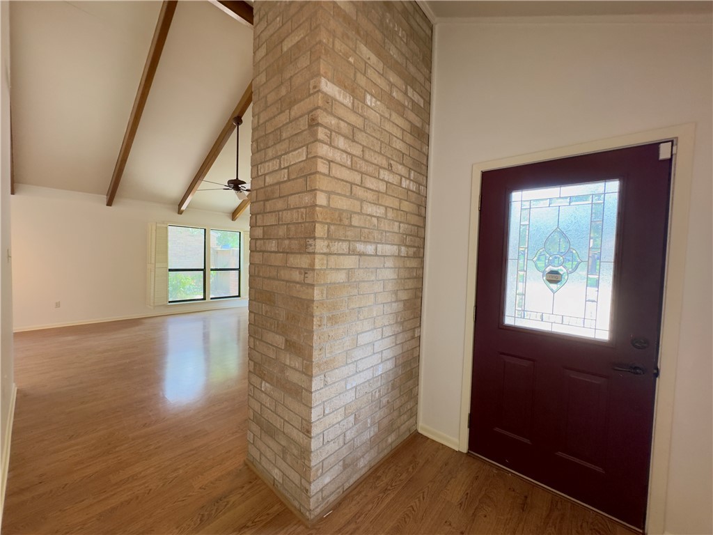 2611 Rustling Oaks Drive Bryan, TX 77802 - Photo 8 of 43 a view of a hallway with wooden floor and a bathroom