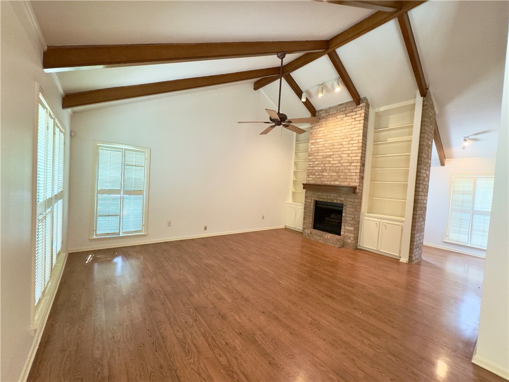 2611 Rustling Oaks Drive Bryan, TX 77802 - Photo 10 of 43 a view of empty room with wooden floor and fireplace