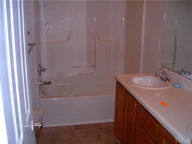 4017 Beaufain Street Raleigh, NC 27604 - Photo 5 of 8 a bathroom with a sink and a mirror